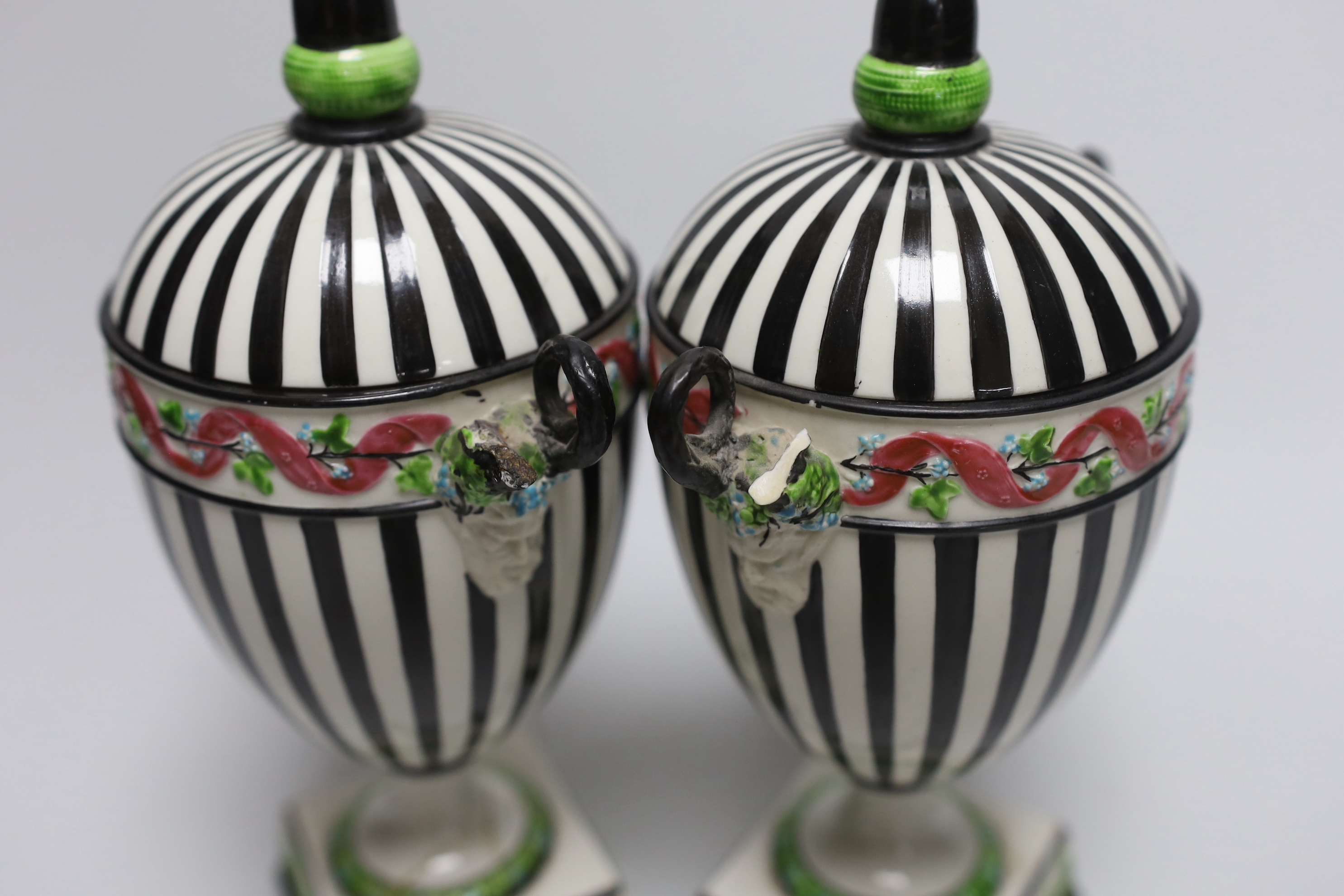 A pair of Wedgwood urns with twin handles and acorn design knops, each 22cm high